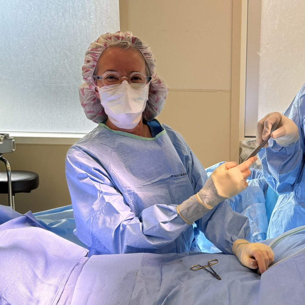 A portrait of Dr. Alexander in scrubs during a surgical procedure.